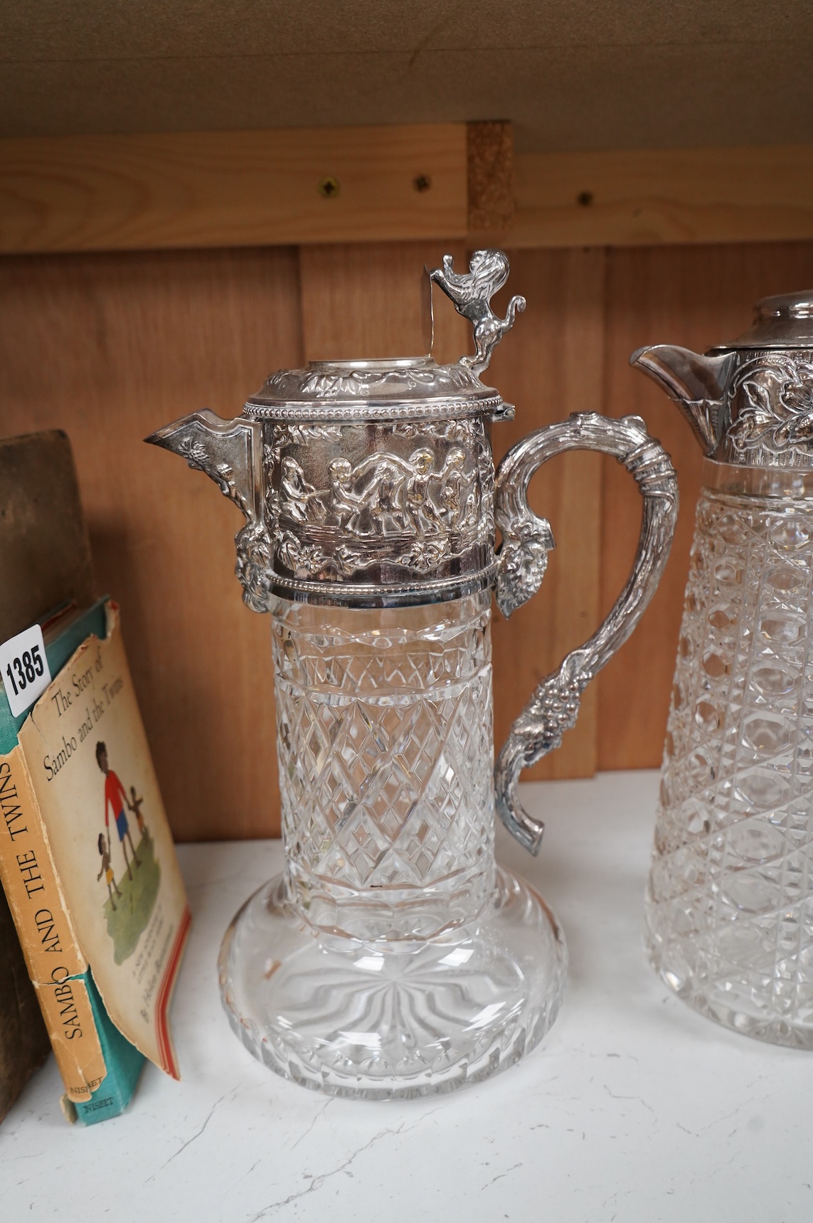 A silver plate mounted glass lemonade jug and a similar claret jug, largest 29cm high